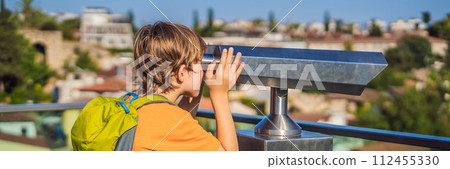 BANNER, LONG FORMAT Boy tourist looks through binoculars in Old town Kaleici in Antalya. Turkiye. Panoramic view of Antalya Old Town port, Taurus mountains and Mediterrranean Sea, Turkey. Traveling BANNER, LONG FORMAT Boy tourist looks through binoculars in Old town Kaleici in Antalya. Turkiye. Panoramic view of Antalya Old Town port, Taurus mountains and Mediterrranean Sea, Turkey. Traveling 112455330
