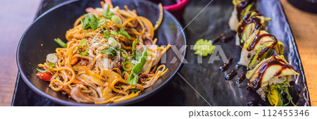 Asian noodles and sushi in black bowl BANNER, LONG FORMAT Asian noodles and sushi in black bowl BANNER, LONG FORMAT 112455346