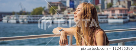 Happy woman enjoying the sea from ferry boat crossing Bosphorus in Istanbul. Summer trip to Istanbul BANNER, LONG FORMAT Happy woman enjoying the sea from ferry boat crossing Bosphorus in Istanbul. Summer trip to Istanbul BANNER, LONG FORMAT 112455390