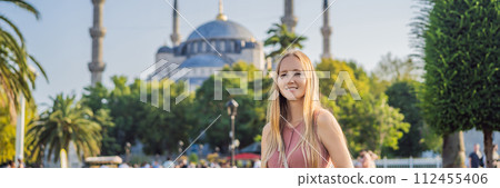 Woman tourist enjoying the view Blue Mosque, Sultanahmet Camii, Istanbul, Turkey BANNER, LONG FORMAT 112455406