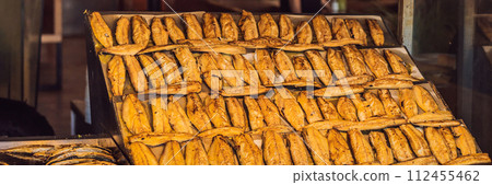The Best Street Food in Istanbul. Preparing the famous Balik Ekmek or Fish Sandwich at a restaurant on the Galata Bridge in Istanbul, Turkey BANNER, LONG FORMAT The Best Street Food in Istanbul. Preparing the famous Balik Ekmek or Fish Sandwich at a restaurant on the Galata Bridge in Istanbul, Turkey BANNER, LONG FORMAT 112455462
