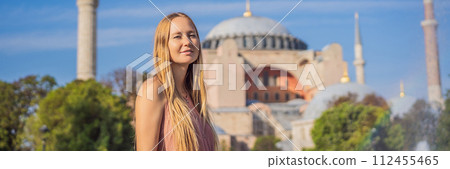 BANNER, LONG FORMAT Woman enjoy beautiful view on Hagia Sophia Cathedral, famous islamic Landmark mosque, Travel to Istanbul, Turkey. Sunny day architecture and Hagia Sophia Museum, in Eminonu BANNER, LONG FORMAT Woman enjoy beautiful view on Hagia Sophia Cathedral, famous islamic Landmark mosque, Travel to Istanbul, Turkey. Sunny day architecture and Hagia Sophia Museum, in Eminonu 112455465