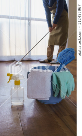 Cleaning tools | Person cleaning the floor with a wiper 112455967