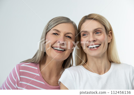 Mother and daughter having good time together and looking happy Mother and daughter having good time together and looking happy 112456136