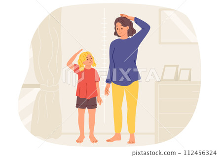 Little girl and mother measure own height standing near wall with marks in apartment. Little girl and mother measure own height standing near wall with marks in apartment. 112456324