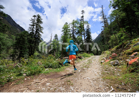 Woman trail runner cross country running in high altitude mountains 112457247