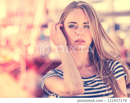 Girl enjoying summer breeze at sunset in marina Girl enjoying summer breeze at sunset in marina 112457278
