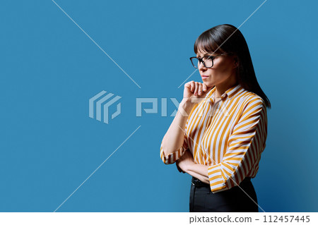 Sad serious mature woman, profile view on blue background 112457445
