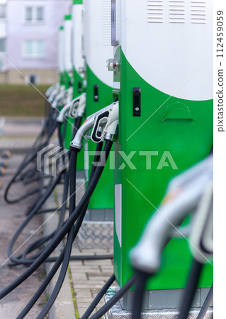Car parking with charging stations near a multi-storey apartment building. Car parking with charging stations near a multi-storey apartment building. 112459059