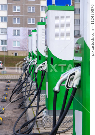 Car parking with charging stations near a multi-storey apartment building. Car parking with charging stations near a multi-storey apartment building. 112459076