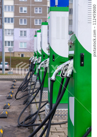 Car parking with charging stations near a multi-storey apartment building. Car parking with charging stations near a multi-storey apartment building. 112459080