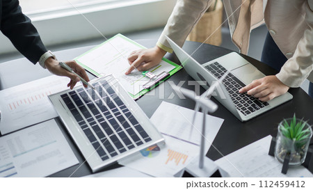 Alternative energy environment businesspeople checking solar cell panel and discuss about document Alternative energy environment businesspeople checking solar cell panel and discuss about document 112459412