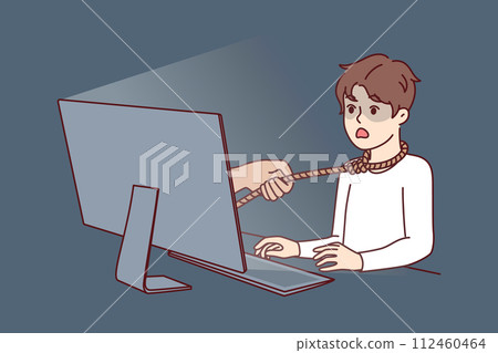 Boy suffering from internet addiction sits at table with computer with rope around neck Boy suffering from internet addiction sits at table with computer with rope around neck 112460464