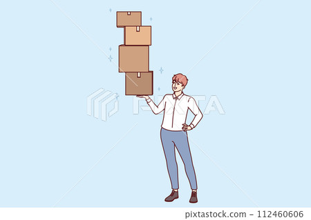 Successful man lifts several boxes with ease, demonstrating professional skills in fulfillment 112460606