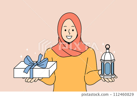 Muslim woman invites to celebrate ramadan, holy islamic holiday, holding gift box and lantern Muslim woman invites to celebrate ramadan, holy islamic holiday, holding gift box and lantern 112460829