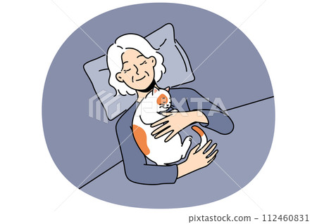 Smiling old woman lying in bed with cat on chest Smiling old woman lying in bed with cat on chest 112460831