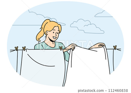 Smiling woman hanging clothes to dry 112460838