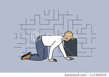 Man searching exit from labyrinth, crawling near miniature door, as metaphor for difficult situation 112460876