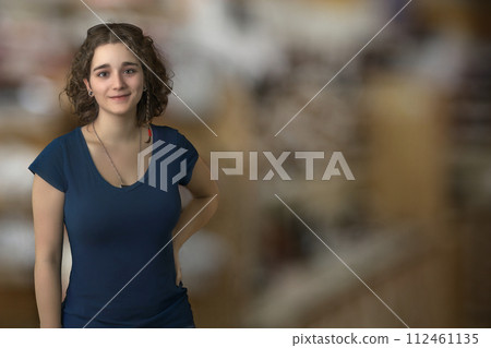 young woman brunette curly hair student standing on bokeh blur copy space background young woman brunette curly hair student standing on bokeh blur copy space background 112461135