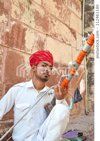 Indian street musician playing Ravanahatha traditional instrument in Rajasthan 112461180