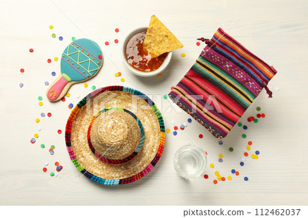 Nachos with sombrero and tequila on a light background 112462037