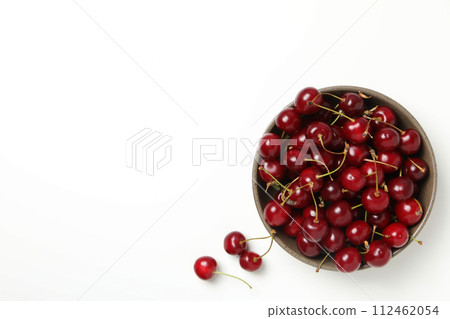 Ripe cherry fruits in a bowl on a white background Ripe cherry fruits in a bowl on a white background 112462054