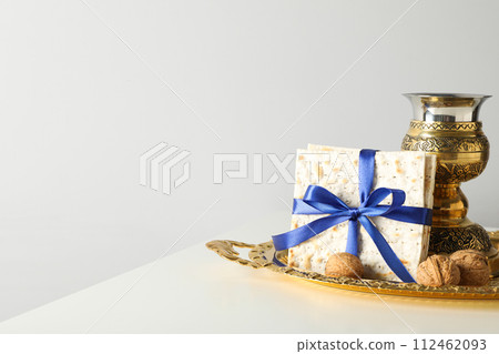 Matzo, nuts and cup on tray on light background, space for text Matzo, nuts and cup on tray on light background, space for text 112462093