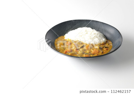 A photo of piping hot curry rice with plenty of vegetables such as pork, pumpkin, and carrots against a white background. A photo of piping hot curry rice with plenty of vegetables such as pork, pumpkin, and carrots against a white background. 112462157