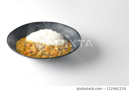 A photo of piping hot curry rice with plenty of vegetables such as pork, pumpkin, and carrots against a white background. A photo of piping hot curry rice with plenty of vegetables such as pork, pumpkin, and carrots against a white background. 112462158