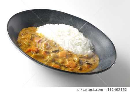 A photo of piping hot curry rice with plenty of vegetables such as pork, pumpkin, and carrots against a white background. A photo of piping hot curry rice with plenty of vegetables such as pork, pumpkin, and carrots against a white background. 112462162