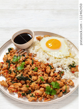 basil chicken stir fry with rice and fried egg basil chicken stir fry with rice and fried egg 112462450