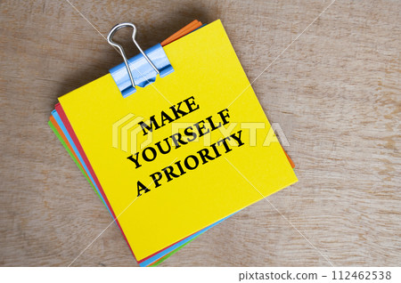 Make yourself a priority text on yellow notepad. Motivational concept. Make yourself a priority text on yellow notepad. Motivational concept. 112462538