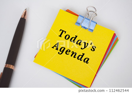Today's agenda text on yellow notepad. Business meeting Agenda. Today's agenda text on yellow notepad. Business meeting Agenda. 112462544