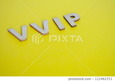 VIP wooden letters representing Very Very Important People on yellow background 112462551