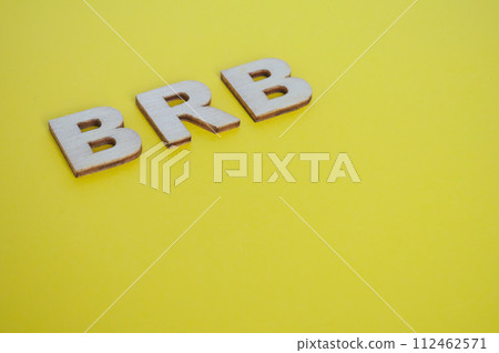BRB wooden letters representing Be Right Back on yellow background BRB wooden letters representing Be Right Back on yellow background 112462571