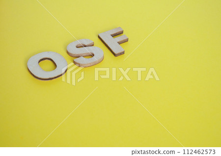 OSF wooden letters representing Open Science Framework on yellow background 112462573