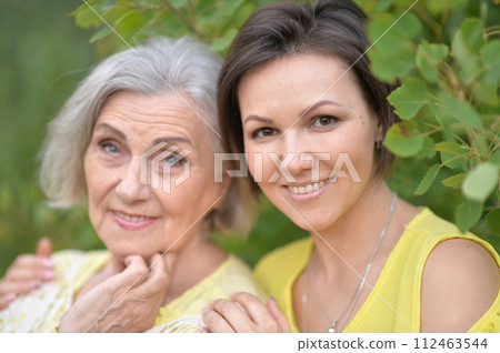 Beautiful elderly woman with her daughter walking in park 112463544