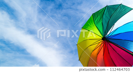 Colorful rainbow umbrella on blue sky background. LGBT, Pride Month, diversity, Sunprotect Concept. Colorful rainbow umbrella on blue sky background. LGBT, Pride Month, diversity, Sunprotect Concept. 112464703
