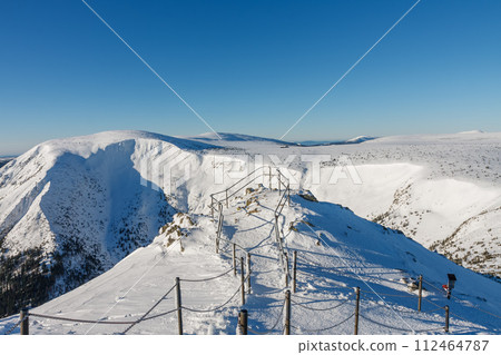 Winter morning , steel railing tube with a chain on danger path from Silesian house to Snezka, mountain on the border between Czech Republic and Poland. 112464787