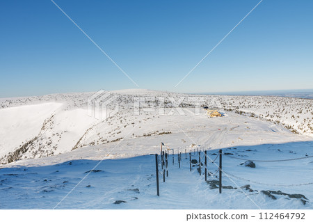 Winter morning , steel railing tube with a chain on path from Snezka to Silesian house, krkonose mountains. Snezka is mountain on the border between Czech Republic and Poland. Winter morning , steel railing tube with a chain on path from Snezka to Silesian house, krkonose mountains. Snezka is mountain on the border between Czech Republic and Poland. 112464792