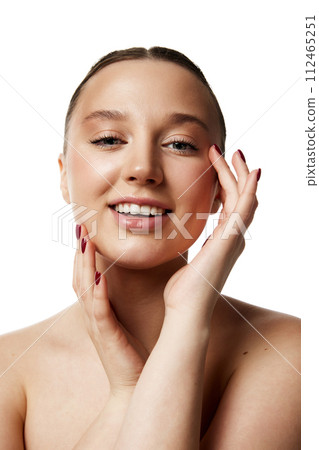 Elegant young lady with pure complexion showing natural, daily make up against white studio background. Self-care. 112465251