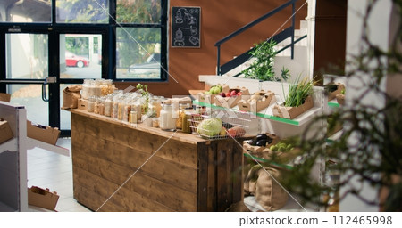 Bulk products in reusable glass jars used by zero waste small business store to lower climate impact and support sustainable lifestyle. Local supermarket with pantry supplies. 112465998