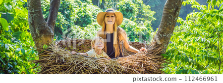 BANNER, LONG FORMAT Bali trend, straw nests everywhere. Young tourist enjoying her travel around Bali island, Indonesia. Making a stop on a beautiful hill. Photo in a straw nest, natural environment BANNER, LONG FORMAT Bali trend, straw nests everywhere. Young tourist enjoying her travel around Bali island, Indonesia. Making a stop on a beautiful hill. Photo in a straw nest, natural environment 112466961