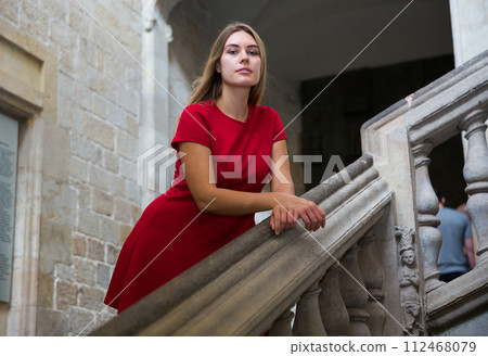 Beautiful girl walks through the old European streets 112468079