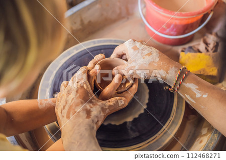 Father and son doing ceramic pot in pottery workshop Father and son doing ceramic pot in pottery workshop 112468271