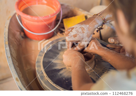 Father and son doing ceramic pot in pottery workshop Father and son doing ceramic pot in pottery workshop 112468276