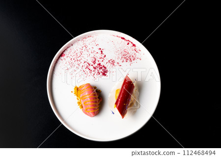 Italian Sicilian cannolo dessert closeup on white plate macro with crust and ricotta cheese 112468494