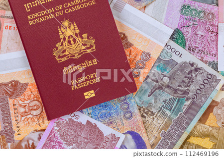Cambodian passports over Cambodian banknotes in different Riels 112469196