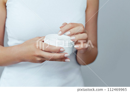 Hand Skin Care. Close Up Of Female Hands Holding Cream Tube, Woman Hands With Natural Manicure Nails Applying Cosmetic Hand Cream On Soft Silky Healthy Skin. Beauty And Body Care Concept Hand Skin Care. Close Up Of Female Hands Holding Cream Tube, Woman Hands With Natural Manicure Nails Applying Cosmetic Hand Cream On Soft Silky Healthy Skin. Beauty And Body Care Concept 112469965
