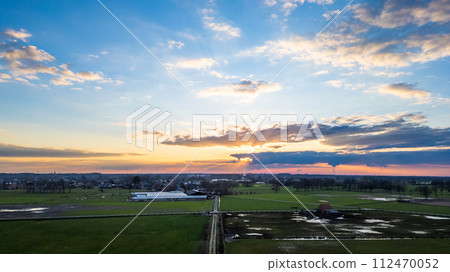 Sunset Sky Over Farmland: A Majestic Display of Clouds and Light 112470052